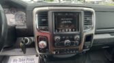 Interior view of a vehicle dashboard showing a centered touchscreen and gear selector (PRND) with a welcome screen on the display.