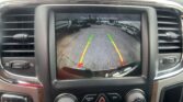 Infotainment screen showing rearview camera with parking guideline lines and the message 'Check Entire Surroundings'.