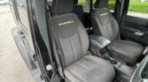 Front car seats in black fabric with white contrast stitching and 'SAHARA' embroidered on the headrests.