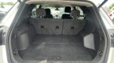 Open SUV trunk with rear seats upright and empty cargo area for storage use