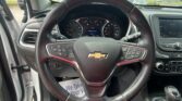 Driver's view of a Chevrolet interior with steering wheel, instrument cluster, and center touchscreen display.