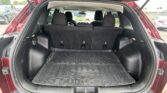 Open tailgate of red SUV; roomy cargo area with rear seats upright and a black rubber cargo mat.