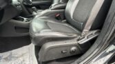 Front interior of a car with black leather seats, center console, and gear shifter visible on the driver’s side area.