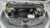 Front view of a car with the hood open, exposing the engine bay, battery, and wiper blades.