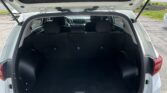 Open SUV hatch showing a spacious, empty cargo area with the rear seats upright and the dashboard visible through the cabin window.