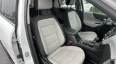 Front and back seats of a gray car interior with diamond-stitched upholstery; raindrops on the windows outside the car doors open to reveal the interior.