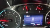 Car dashboard: speedometer showing 0 MPH on a digital screen, tachometer on left, fuel gauge near E with red needle, gear letters PRNDL at bottom, odometer reading 85836 miles, dashboard warning lights faintly visible.