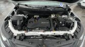 Open hood of a Chevrolet showing the engine bay and ECOTEC engine cover with windshield and wipers in the background, wet from rain.