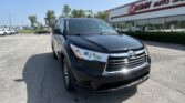 Black Toyota SUV in the dealership lot, with EZ Loan Auto Sales storefront in the background on a sunny day