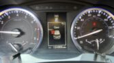 Close-up of a car dashboard: tachometer left, speedometer right, center display shows Outside 79°F and gear in P with 'Open' door indication below and odometer 124,906 miles.
