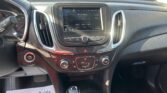 Car interior featuring a touchscreen infotainment system displaying '39 Hair Nation' station, with steering wheel and gear shifter nearby.