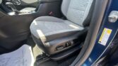Interior of a car front passenger seat area with center console and gear shifter visible on the left side of the image.