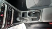 Center console of a car interior with gear shifter, two cup holders, and climate/media controls visible on the dash. Floor mat reads 'SONATA'.