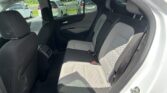 Rear seat view inside a car with two-tone gray upholstery and headrests visible