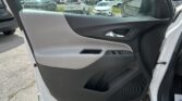Interior of a white car door: gray and black trim, chrome door handle, and power window/lock controls on the armrest