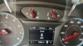 Close-up of a car dashboard: fuel gauge near empty, engine temp gauge warm, and a digital display showing 0 mph with odometer reading 91,964 miles; seatbelt warning glow visible. Park indicator also shown.