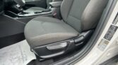 Interior of a car showing the front seats, center console, and gear shifter in dark fabric upholstery.