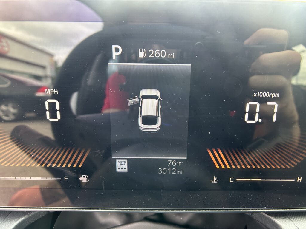 Digital car instrument cluster: Park (P), fuel range 260 miles, speed 0 mph, RPM 0, temperature 76°F, odometer 3,012 mi.