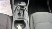 Center console of a car showing gear shift, cup holders, and USB/12V ports under the dashboard area.