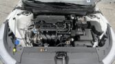 Under-hood view of a car engine bay with a 'Smartstream G DOHC 16V' engine cover, battery on the right, and various hoses and components visible.