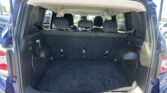Open tailgate of a blue SUV showing a spacious cargo area with the second and third-row seats upright.