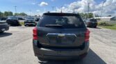 Rear view of a Chevrolet Equinox AWD SUV in a parking lot with other vehicles and power lines overhead.
