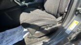 Interior of a car showing the front passenger seat, center console, and seat belt buckle with a protective sheet on the floor mat