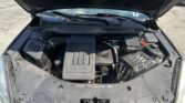 Open car hood exposing engine bay; center features an ECOTEC engine cover with surrounding hoses and components visible.