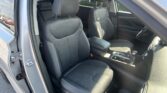 Interior of a car showing the front two cloth seats with adjustable headrests, center console, and part of the steering wheel visible on the right.