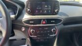 Center dashboard touchscreen showing AV Off with surrounding control buttons and climate controls below (car interior).