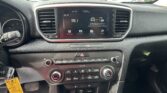 Center console of a car showing a touchscreen radio at 95.1 FM with climate controls beneath and air vents on both sides.