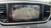 Rearview camera display showing parking guidance lines and the message 'Check surroundings for your safety.'