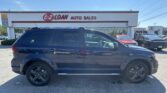 Blue SUV parked in front of EZ Loan Auto Sales storefront on a sunny day.