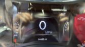 Digital car dashboard: center displays 0 MPH with odometer 94582 mi; right shows 83°F and gear PRN D; left shows SE direction.