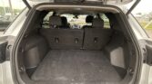 Open SUV trunk with a spacious cargo area and folded rear seats visible behind the second row