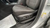 Interior of a car showing the front seat, center console with gear shifter, and papers on the floor near the door.