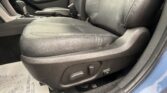 Front interior of a car showing the driver and passenger seats with visible seat controls and center console in a black leather finish.