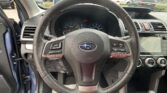 Driver's view of the steering wheel with instrument cluster and center console visible in a parked car