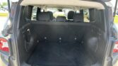 Open tailgate view of SUV cargo area with third-row seats folded and black interior, showing spacious storage space.