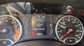 Car dashboard with RPM and speed gauges, center screen shows 'Engine Running' and odometer reads 84,657 miles, gear in P.