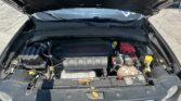 Front of a car with hood open, exposing the engine bay and an engine cover labeled 2.4L MultiAir.