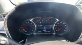 View from the driver’s seat showing the car’s dashboard: speedometer at 0 mph, tachometer, and digital display reading 9,9682 miles on the odometer with gear indicator PRNDL visible.