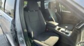 Open car door showing the gray fabric front seats and center console in daylight, SUV interior.**Note**: remove the bold if needed in your system.