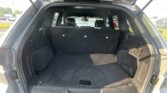 Rear cargo area of an SUV with third-row seats upright and space behind them.