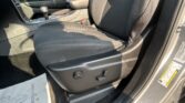 Interior of a car showing the front seats, center console with gear shifter and armrest, and seat adjustment controls.
