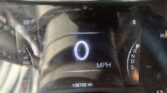 Digital car dashboard: speedometer shows 0 MPH, outside temperature 68°F, gear in Park (P), odometer reads 106,702 miles, and a red warning light is visible bottom left.