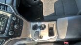 Interior of a car showing the center console, gear shifter, cup holder, and passenger seat from a slightly overhead angle