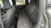 Back seat area of a dark gray SUV with fabric seats and visible headrests, seen from the open rear door.