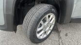 Front right wheel of a gray SUV, tire tread visible inside the wheel well