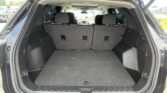 Open SUV hatch showing full cargo area with rear seats upright and spacious trunk.